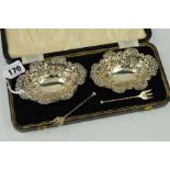 A PAIR OF LATE VICTORIAN SILVER BON BON DISHES, of wavy oval form, embossed with foliate scrolls,