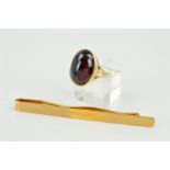 A LATE 20TH CENTURY 9CT GOLD LARGE GARNET RING, an oval cabochon measuring approximately 17mm x