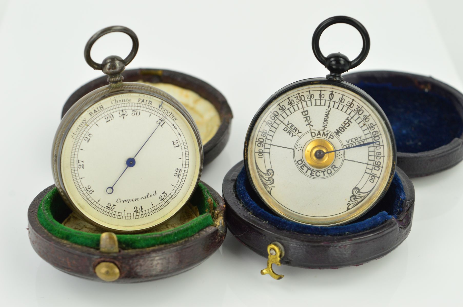 TWO CASED POCKET BAROMETERS, both of circular outline with hinged antique circular cases, the