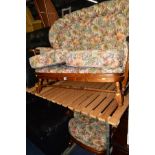 AN OAK FRAMED FLORAL UPHOLSTERED SPINDLE BACK TWO SEATER SETTEE, together with a matching chair (2)