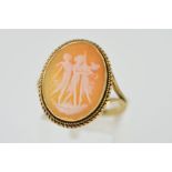 A 9CT GOLD CAMEO RING, the oval panel carved to depict the Three Graces, within a double rope