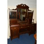 AN EDWARDIAN OAK MIRROR BACK SIDEBOARD with three various drawers and double panelled doors,