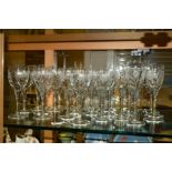 A SET OF CUT GLASSES, with etched 'Fuchsias', consisting of seven champagne flutes, eight red wine