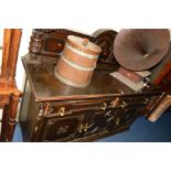 AN EARLY 20TH CENTURY CARVED OAK SIDEBOARD, of geometric form, with a raised back flanked by bulbous