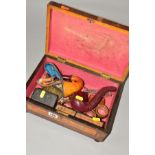A VICTORIAN ROSEWOOD AND WALNUT WORK BOX AND CONTENTS, the work box in need of restoration, the