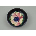 A SMALL MOORCROFT FOOTED POTTERY BOWL, Anemone pattern on blue ground, impressed marks to base,