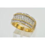A 9CT GOLD DIAMOND BAND RING, designed as a wide tapered band with diagonal bands pave set with