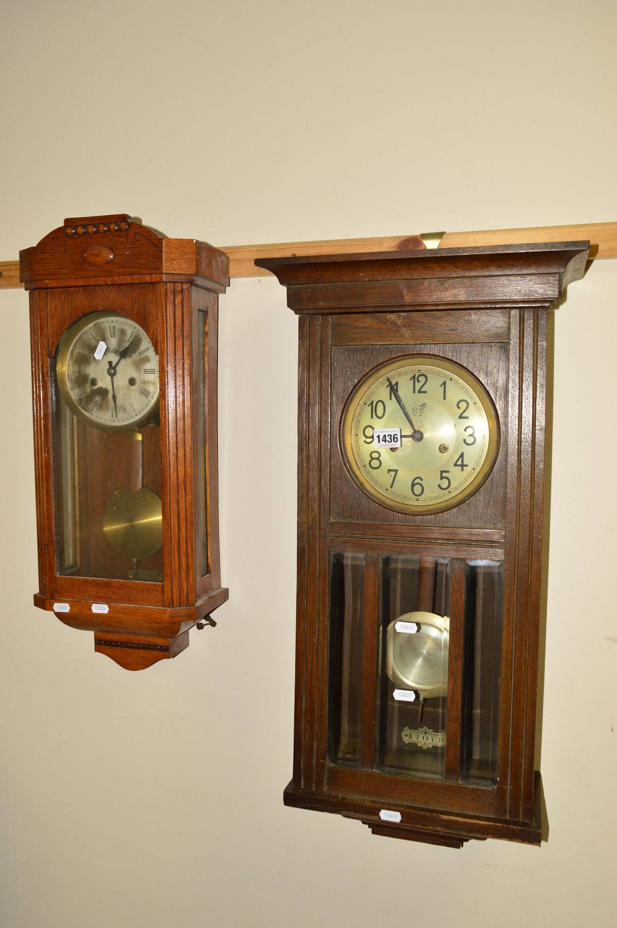 AN EARLY 20TH CENTURY OAK WALL CLOCK, together with another oak wall clock (2)