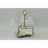 A SILVER PLATED TANTALUS, of trefoil form, with loop handle containing three cut glass decanters and