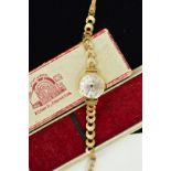 A 9CT GOLD LADIES SKONDA WRISTWATCH, the circular face with metallic colouring, Arabic numerals,