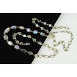 A LONG MOONSTONE NECKLACE, designed as links of near oval and near circular moonstone cabochons