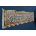 A 20TH CENTURY WOOLLEN CARPET RUNNER, pink and cream ground, approximately 244cm x 70cm