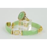 A 9CT GOLD JADE BRACELET AND RING, the ring designed as an oval jade cabochon within an open Greek-