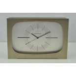 JAEGER-LE-COULTRE, a brushed steel cased clock with a silvered face, applied batons to 3 o'clock and