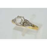 A LATE 19TH CENTURY TO EARLY 20TH CENTURY GOLD SINGLE STONE DIAMOND RING, one old cushion diamond,