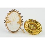 TWO BROOCHES, the first an oval cameo brooch depicting a lady in profile to the scrolling