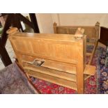 A HEAVY OAK 6' BED FRAME, the headboard fitted with sliding cupboard doors revealing spotlights,