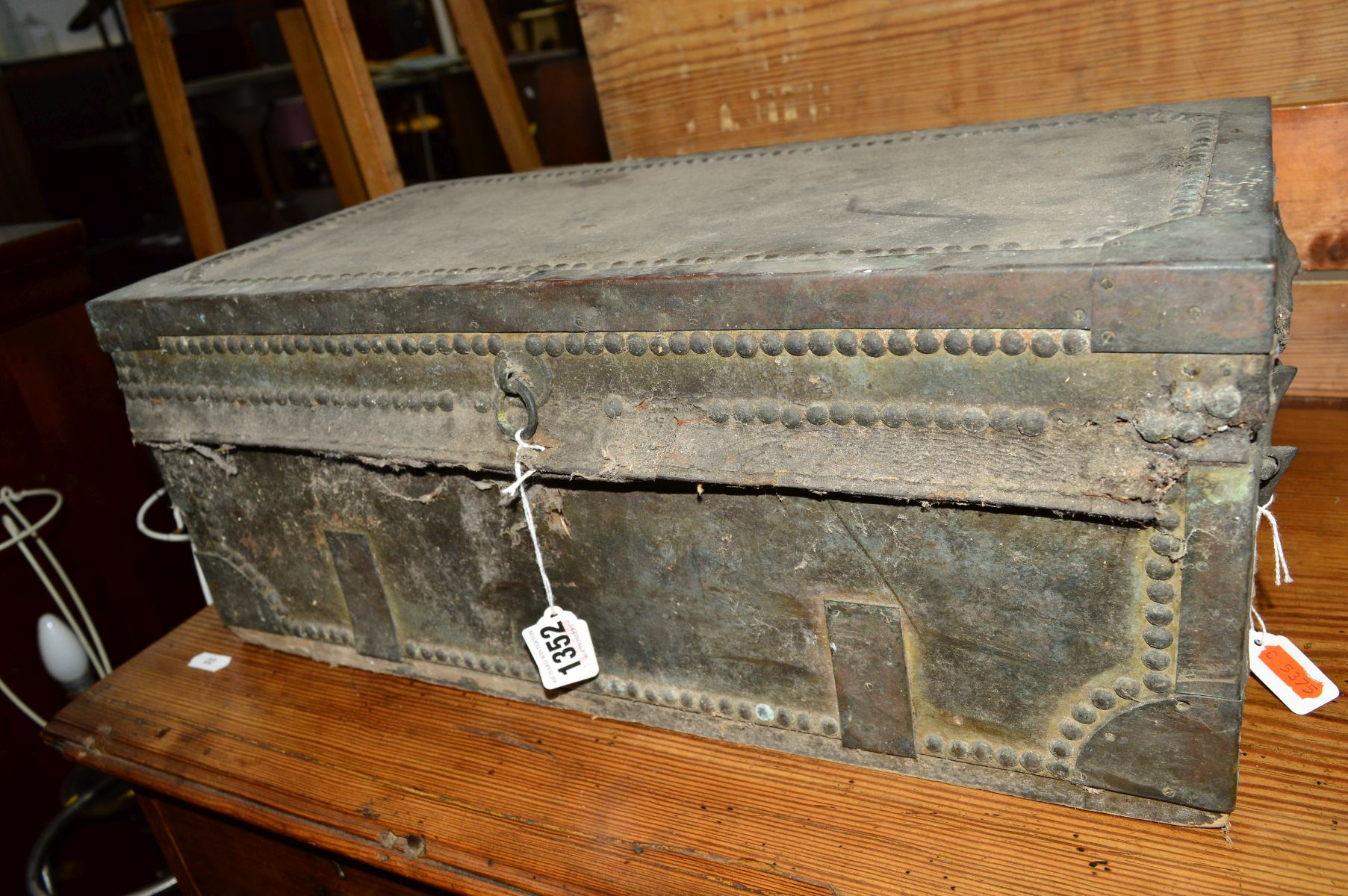 A 19TH CENTURY DISTRESSED HIDE AND METAL BANDED CHEST, with hinged top and double metal handles