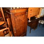 AN OAK SINGLE DOOR CUPBOARD, together with an oak drop leaf dining table (2)