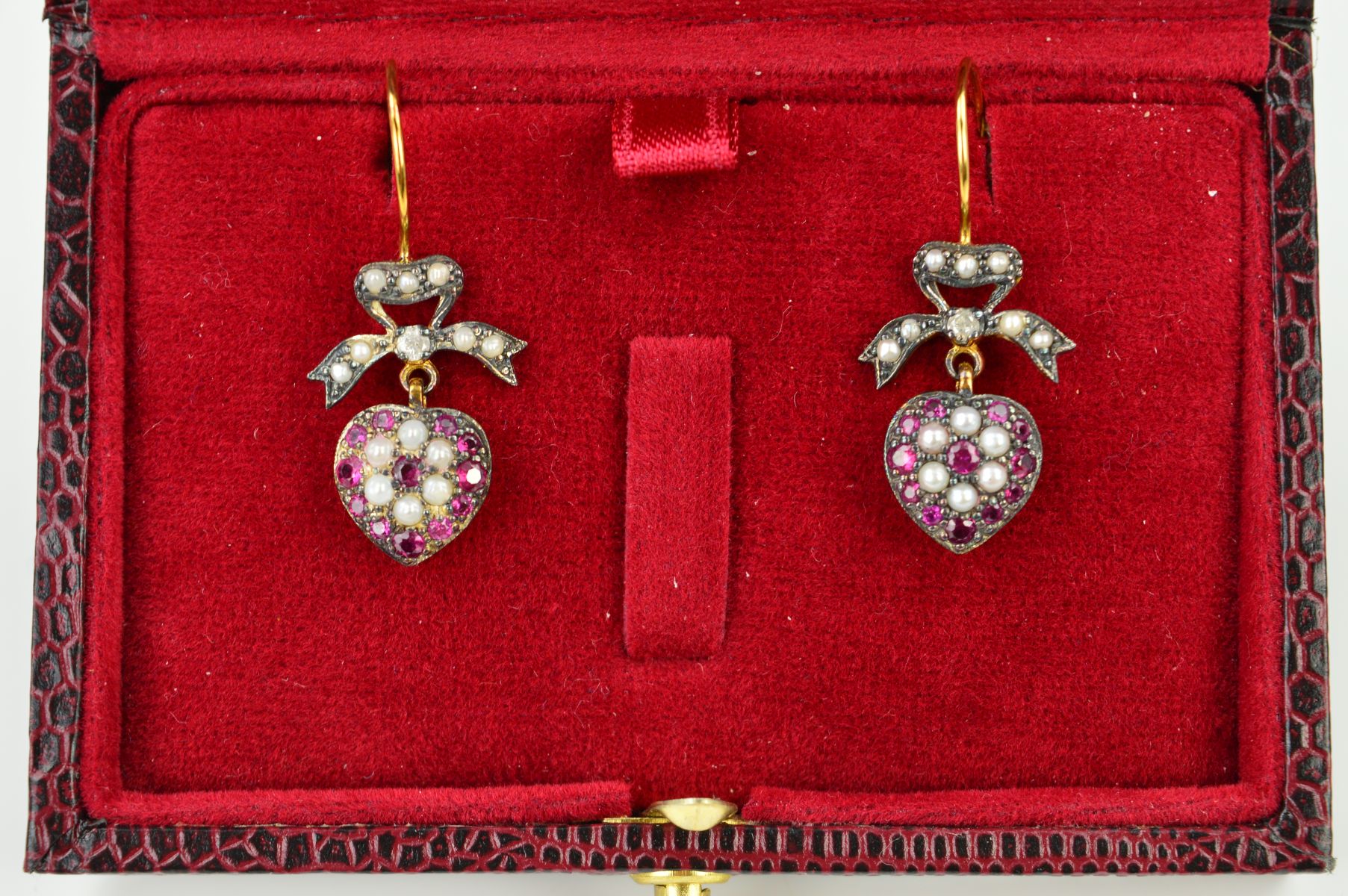 A PAIR OF RUBY, DIAMOND AND SPLIT PEARL DROP EARRINGS, each designed with a heart shape drop set