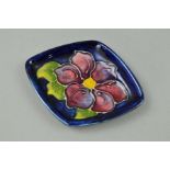 A SMALL MOORCROFT POTTERY TRINKET DISH, 'Clematis' pattern on a blue ground, impressed marks to
