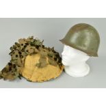 A METAL DATED 1971 BRITISH MILITARY HELMET, with hussian and camoflouge cover, inside the inner