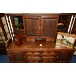 A LARGE EDWARDIAN OAK DRESSER, the upper section with double bevelled glazed doors above flanked