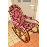 A BENTWOOD OAK ROCKING CHAIR with floral velvet upholstery