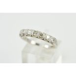 A SEVEN STONE DIAMOND RING, designed as seven brilliant cut diamonds each within a U-shaped gallery,
