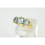 A MODERN THREE STONE AQUAMARINE RING, three oval aquamarines measuring on average 6mm x 4mm, ring