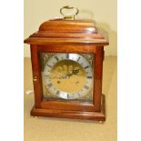 A COMITTI CHIMING MANTLE CLOCK, having a gilt face with applied cherub decoration, silvered