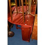 A MODERN DROP LEAF DINING TABLE, with four stowaway folding chairs and two mahogany single door