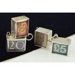 FOUR CHARMS, each rectangular prism containing an old cash note, including two £10, a £20 and a £