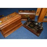 AN OAK CASED SINGER SEWING MACHINE, together with another sewing machine (2)