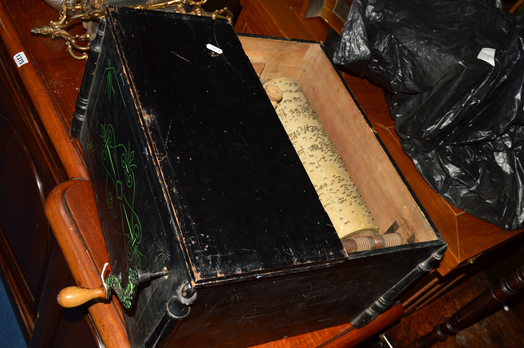 A LATE VICTORIAN TABLE TOP BARREL ORGAN, ebonised square case with Etruscan style decoration, the