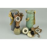 TWO WWII ERA GAS MASKS, in battle grey tins marked on top L.702, these were made in Liege Belgium