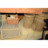 A COLLECTION OF WICKER, comprising of a large clothes basket, a similar smaller basket, a picnic