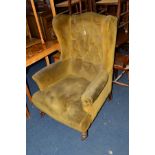 AN EDWARDIAN MAHOGANY GREEN UPHOLSTERED WING BACK ARMCHAIR, (s.d.)