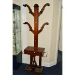 A VICTORIAN MAHOGANY SKELETON HAT STAND, with a hinged storage compartment, flanked by metal rods