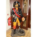 A LIFE SIZE RESIN FIGURE OF A PIRATE, supported on a decorated base, height 188cm (s.d.)