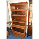 A GLOBE WERNICKE WALNUT FIVE SECTIONAL BOOKCASE, with glazed fall front doors, comprising of four