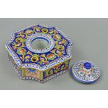 AN EARLY 20TH CENTURY CONTINENTAL FAIENCE INKSTAND, of shaped square form, concave corners, with