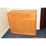AN ERCOL ASH SIDEBOARD, with two drawers and double cupboard doors, width 104.5cm x depth 44cm x