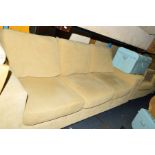 A LIGHT YELLOW UPHOLSTERED THREE PIECE LOUNGE SUITE, comprising of a three seater settee and two