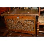AN EARLY 20TH CENTURY CARVED OAK CHEST, with a lidded top, width 54cm x depth 35cm x height 44cm