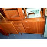 TWO TEAK CASED SINGER SEWING MACHINES, one containing a pale blue model 337 sewing machine (2)