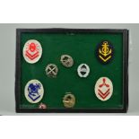 A GLAZED FRAME, (sealed), containing a number of German WWII Kriegsmarine Arm patches for various