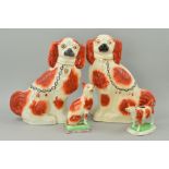 A PAIR OF STAFFORDSHIRE SEATED SPANIELS, brown and white, height approximately 34cm (one s.d.),