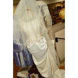 A BRIDAL GOWN, VEIL AND HEADDRESS, together with various handbags, faux fur hat and gloves, pictures
