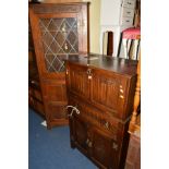 AN OAK LINENFOLD DRINKS CABINET, with a fall front and a single drawer, together with an oak